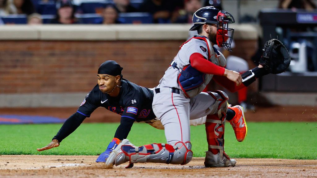 New York Mets' Francisco Lindor, left, scores a runs after beating the throw to Boston Red Sox catcher Connor Wong during the third inning of a baseball game, Monday, Sept. 2, 2024, in New York. (AP Photo/Noah K. Murray)