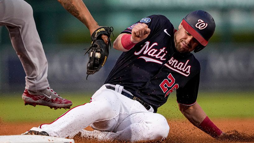 Washington Nationals' Lane Thomas (28) steals third base during the third inning of the team's baseball game against the Boston Red Sox at Nationals Park, Wednesday, Aug. 16, 2023, in Washington. (AP Photo/Andrew Harnik)