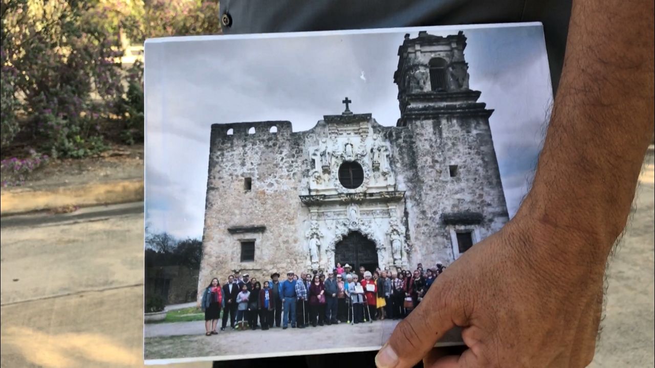 Vasquez holds a book that highlights two families that were descendants of San José (Jose Arredondo/Spectrum News)