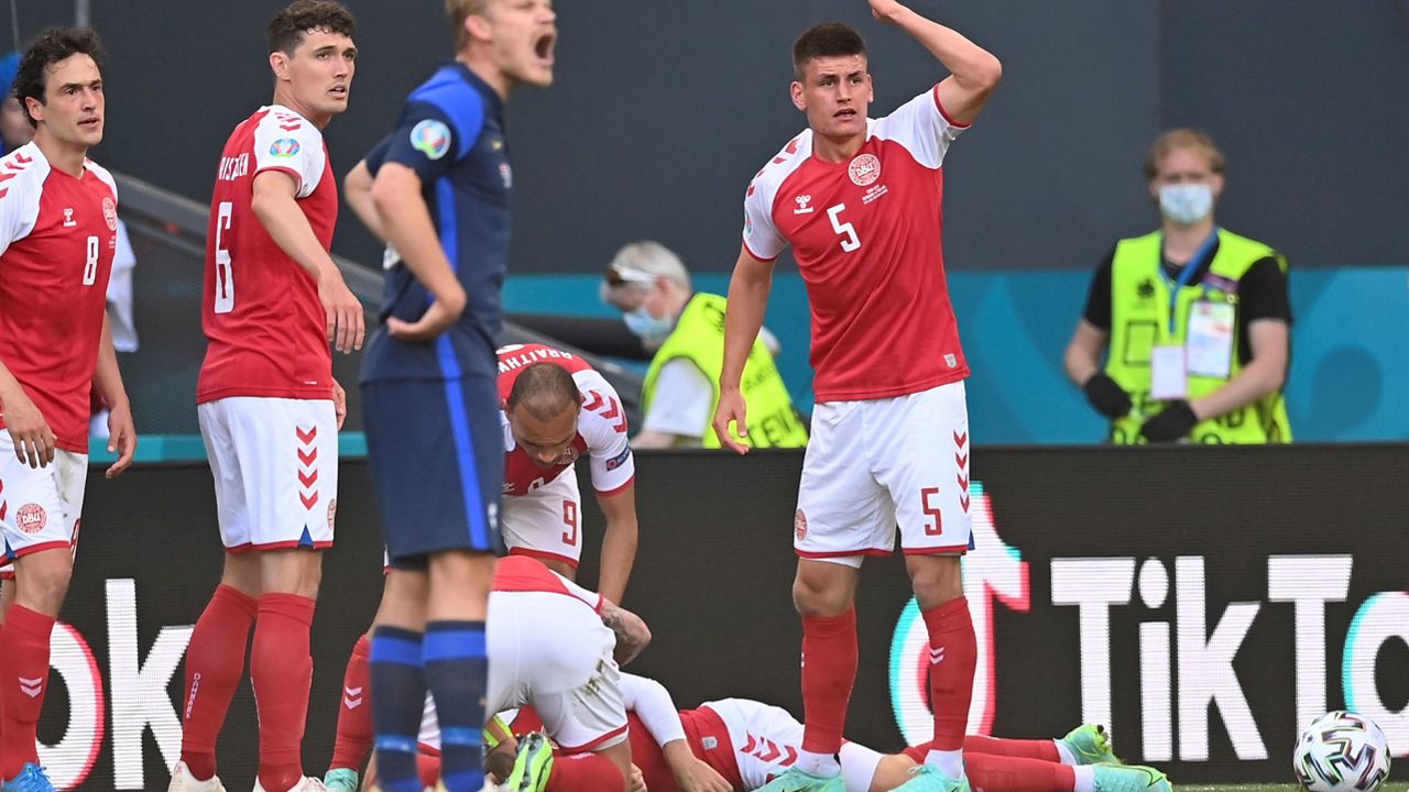 Denmark's Joakim Maehle calls for medical assistance after teammate Christian Eriksen collapsed during a Euro 2020 match . (Stuart Franklin/Pool via AP)