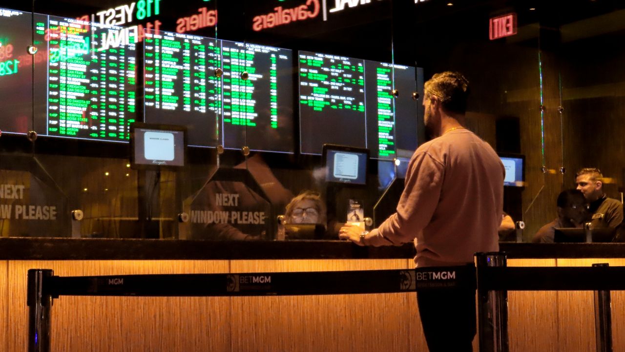 A customer makes a sports bet at the Borgata casino in Atlantic City, N.J., on March 17, 2022, just before the March Madness NCAA college basketball tournament. (AP file photo/Wayne Parry)