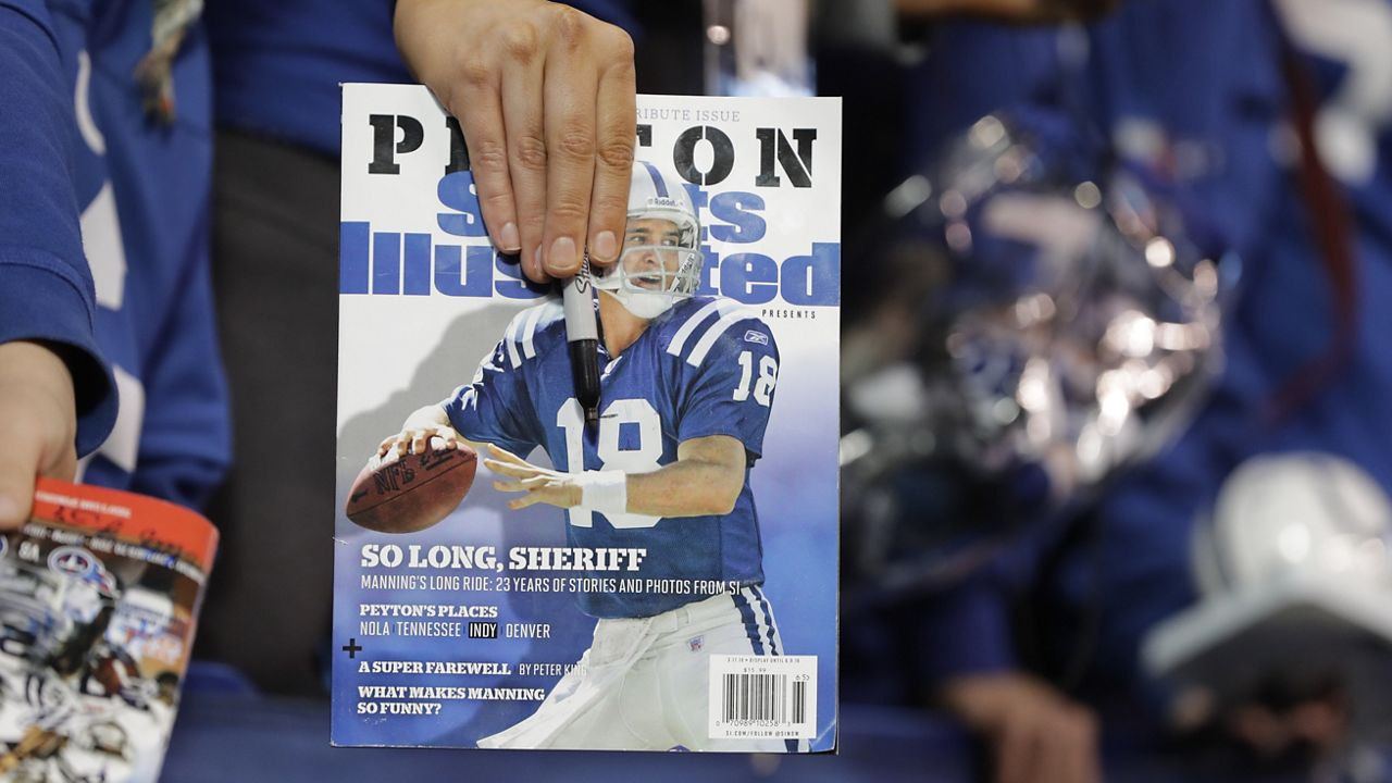 A fan waits for former Indianapolis Colts quarterback Peyton Manning to sign autographs before an NFL football game between the Tennessee Titans and the Indianapolis Colts, Nov. 20, 2016, in Indianapolis. Sports Illustrated is the latest media company damaged by being less than forthcoming about who or what is writing its stories. (AP Photo/Darron Cummings, File)