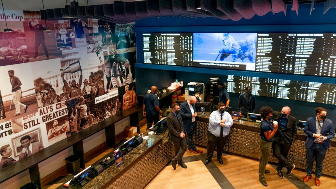 Guests mingle at a ribbon cutting ceremony at the William Hill Sportsbook at Monumental Sports & Entertainment's Capital One Arena in Washington, Wednesday, May 26, 2021. The first full-service sportsbook at a major four North American pro sports venue in the United States opens its doors. (AP Photo/Andrew Harnik)