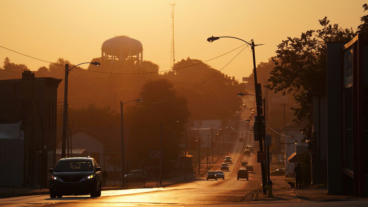 The sun rises over the city of Springfield, Ohio, Monday, Sept. 16, 2024. (AP Photo/Jessie Wardarski)