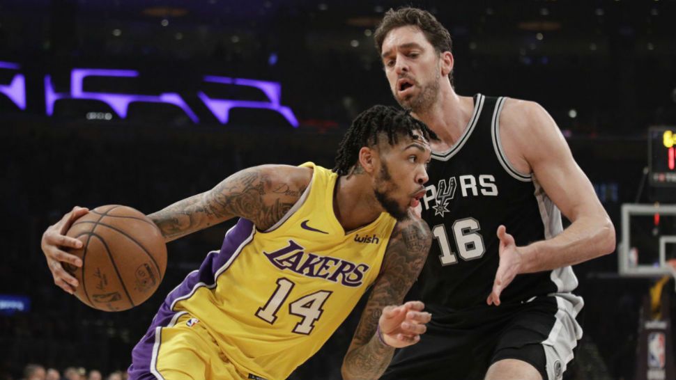 Los Angeles Lakers' Brandon Ingram, left, drives past San Antonio Spurs' Pau Gasol, of Spain, during the first half of an NBA basketball game Thursday, Jan. 11, 2018, in Los Angeles. (AP Photo/Jae C. Hong)