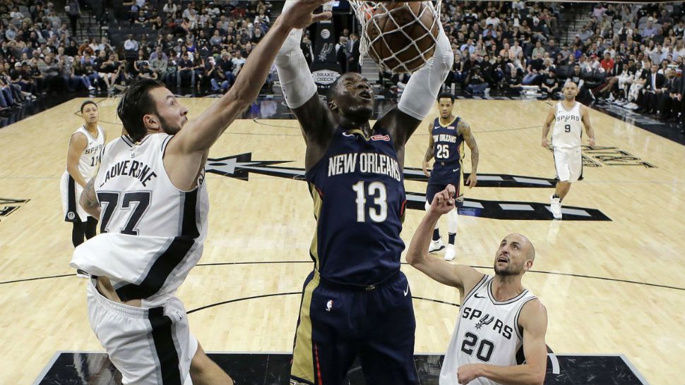 New Orleans Pelicans forward Cheick Diallo (13) scores between San Antonio Spurs center Joffrey Lauvergne (77) and guard Manu Ginobili (20) during the first half of an NBA basketball game Wednesday, Feb. 28, 2018 in San Antonio. (AP Photo/Eric Gay)