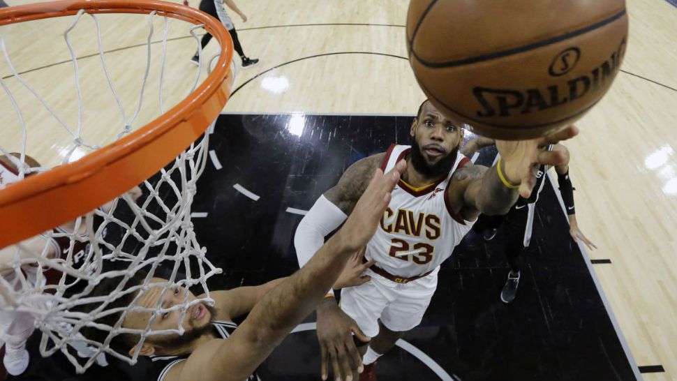 Cleveland Cavaliers forward LeBron James (23) shoots past San Antonio Spurs forward Kyle Anderson (1) during the first half of the NBA basketball game on Tuesday, Jan. 23, 2018 in San Antonio. (AP Photo/Eric Gay)