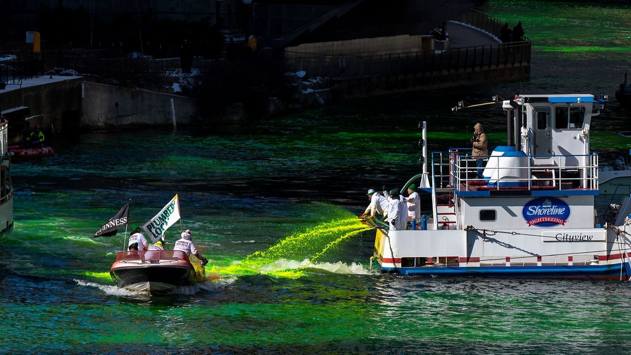 Members of the Plumbers Union Local 130 dye the Chicago River green on Saturday, March 12, 2022.