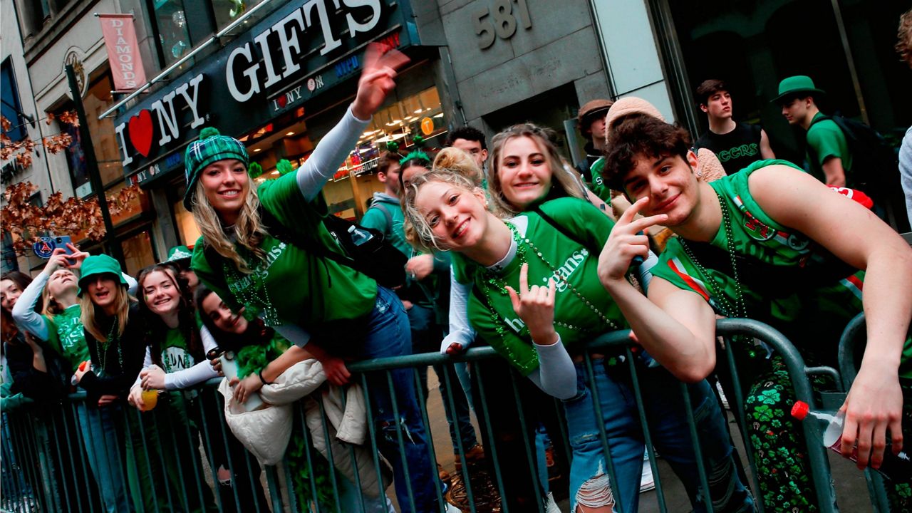 People wait along Fifth Avenue Thursday for the start of the St. Patrick's Day Parade. (AP Photo/Eduardo Munoz Alvarez)