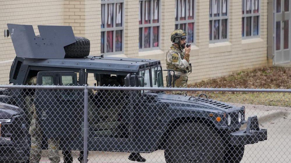 Law enforcement teams stage near Congregation Beth Israel while conducting SWAT operations in Colleyville, Texas on Saturday afternoon, Jan. 15, 2022. (Smiley N. Pool/The Dallas Morning News via AP)