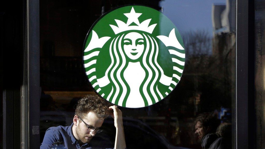 A man sits inside a Starbucks, in New York, Jan. 11, 2016. (AP Photo/Mark Lennihan)