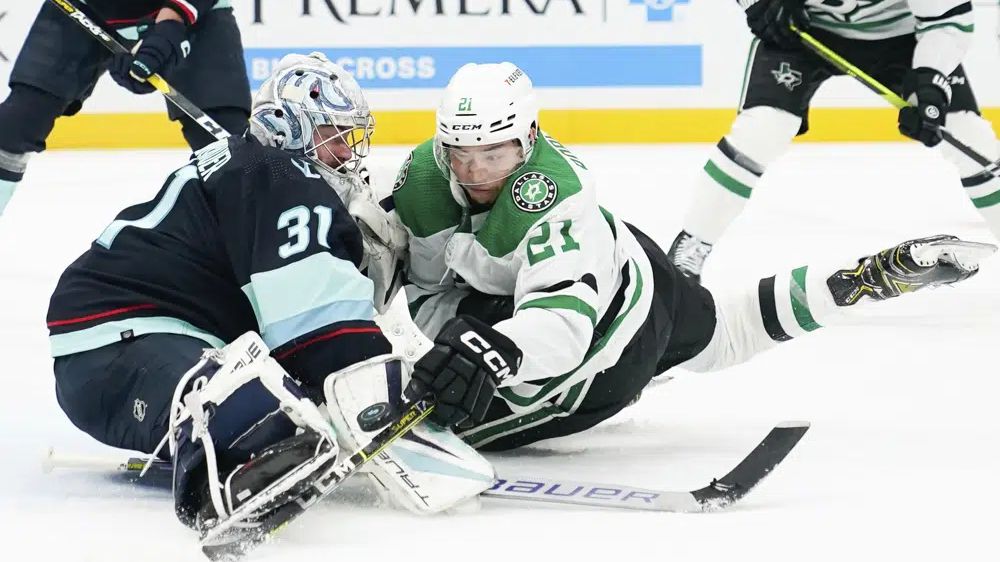 Seattle Kraken goaltender Philipp Grubauer (31) blocks the puck against Dallas Stars left wing Jason Robertson (21) during the second period of Game 3 of an NHL hockey Stanley Cup second-round playoff series Sunday, May 7, 2023, in Seattle. (AP Photo/Lindsey Wasson)