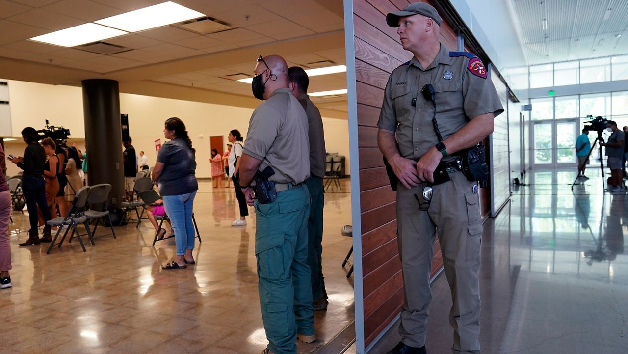 A Texas State Trooper and other members of law enforcement listen to the Texas House investigative committee during a news conference after they released a full report on the shootings at Robb Elementary School, Sunday, July 17, 2022, in Uvalde, Texas. (AP Photo/Eric Gay)