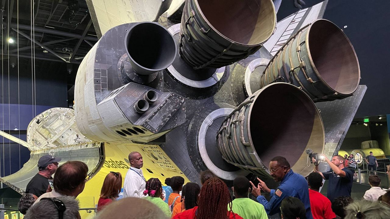 Veteran NASA astronaut Winston Scott explains rockets and their capacity limitations during launch to students from the Tampa-area Boys and Girls Club at Kennedy Space Center Thursday. (Spectrum News 13/Greg Pallone)