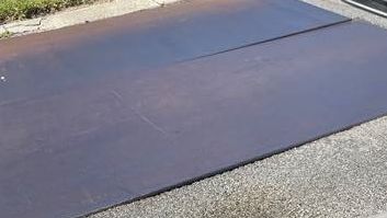 Steel plates were placed over roads where storm pipes have failed. (Photo courtesy by Bill Jones)