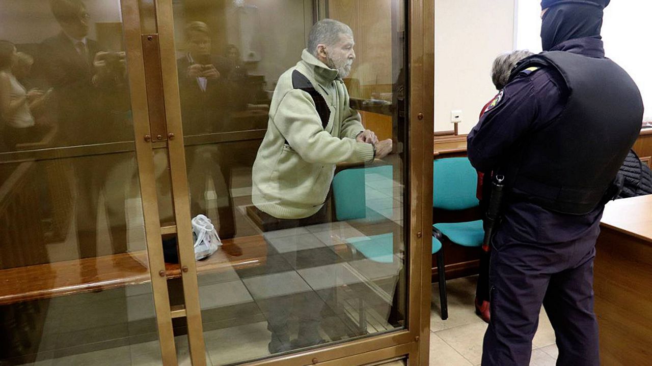 In this photo released by the Moscow City Court Press Service, Stephen Hubbard, a U.S. citizen accused of fighting as a mercenary in Ukraine against Russia, stands in a glass cage during a court session in the Moscow City court in Moscow, Russia, Monday, Oct. 7, 2024. (Moscow City Court Press Service via AP)