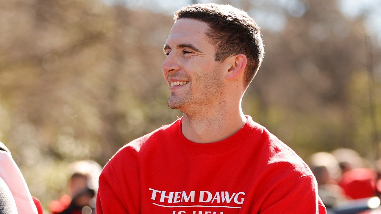 Former Georgia quarterback Stetson Bennett smiles at the crowd during a parade celebrating the Bulldog's second consecutive NCAA college football national championship on Saturday, Jan. 14, 2023 in Athens.