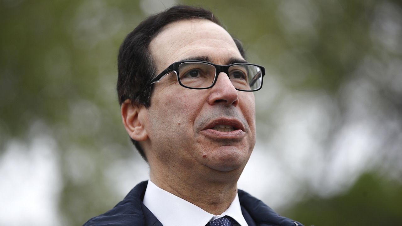 Former Treasury Secretary Steve Mnuchin speaks with reporters outside the White House, March 29, 2020, in Washington. (AP Photo/Patrick Semansky, File)