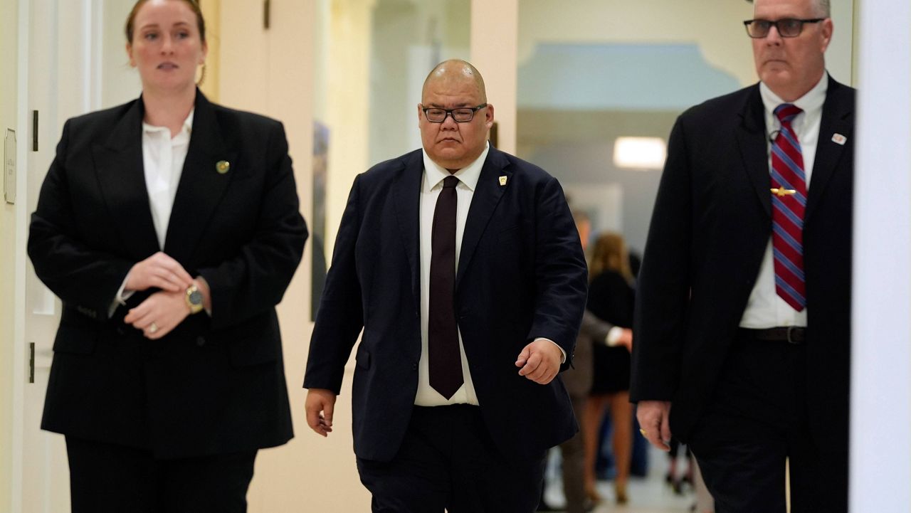 Steven Cheung, center, walks before Republican presidential nominee former President Donald Trump votes on Election Day at the Morton and Barbara Mandel Recreation Center, Tuesday, Nov. 5, 2024, in Palm Beach, Fla. (AP Photo/Evan Vucci)