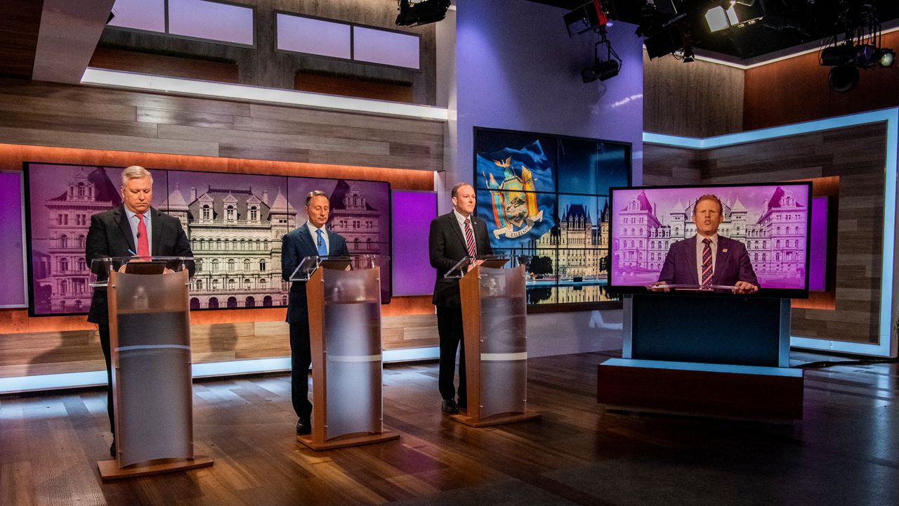 Rep. Lee Zeldin, Harry Wilson, Rob Astorino and Andrew Giuliani are pictured on the Spectrum News debate stage.