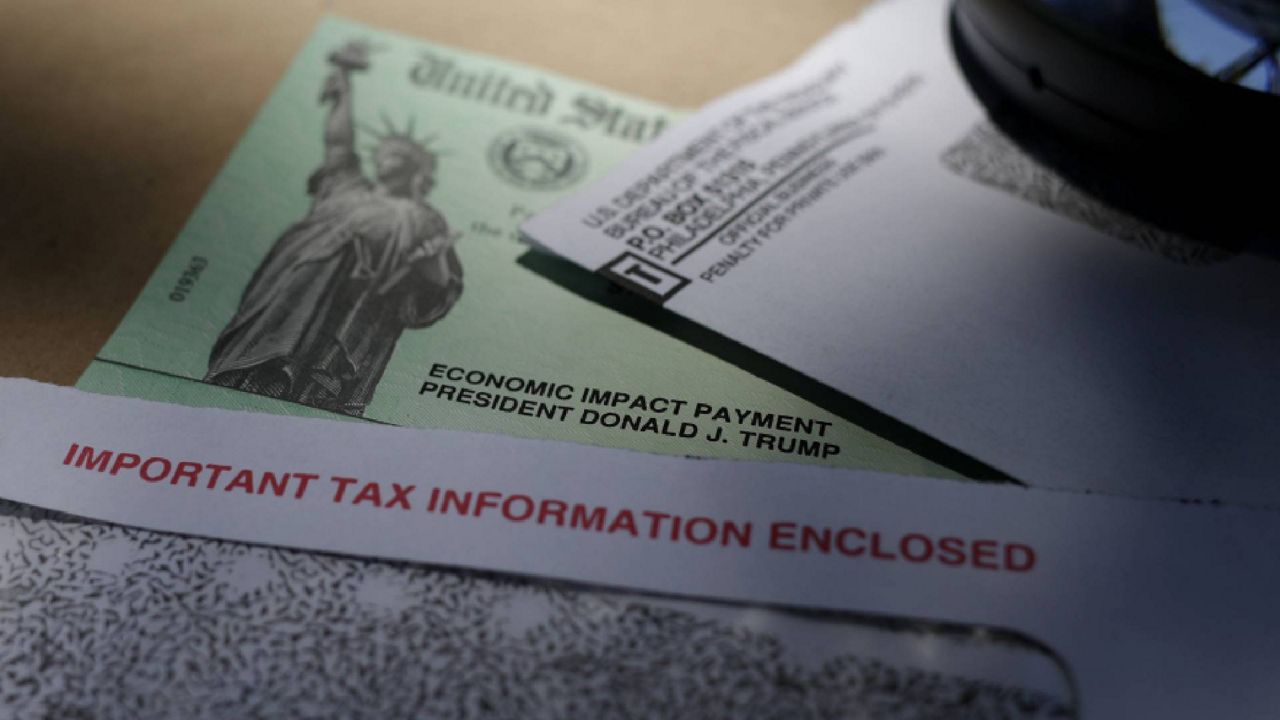 FILE - In this April file photo, President Donald Trump's name is seen on a stimulus check issued by the IRS. (AP Photo/Eric Gay, File)