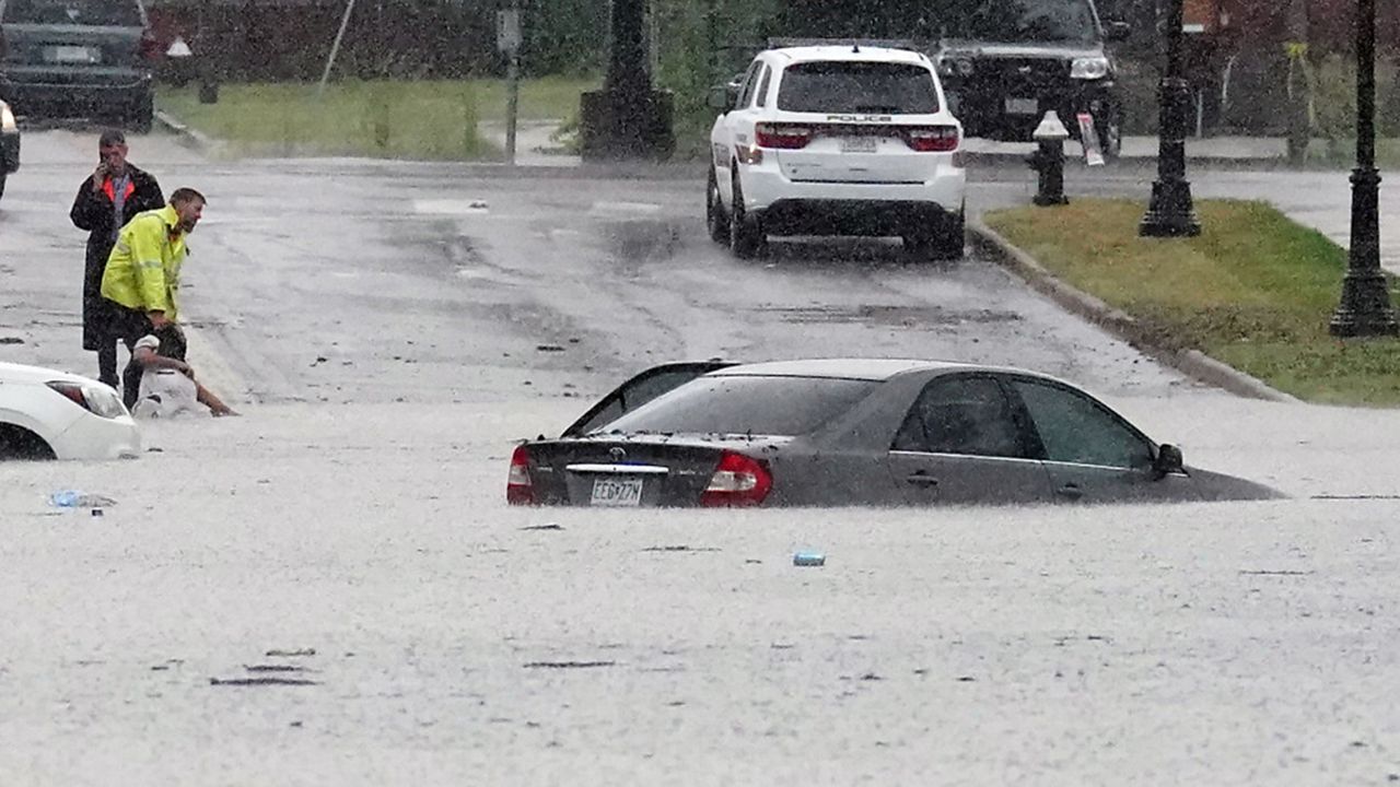 A passerby drags a victim from a flooded vehicle following historic rains causing flooding on streets and houses in St. Louis on Tuesday, July 26, 2022. Some areas in the St. Louis area received over 11 inches of water from heavy rains. (Photo by Bill Greenblatt/UPI)