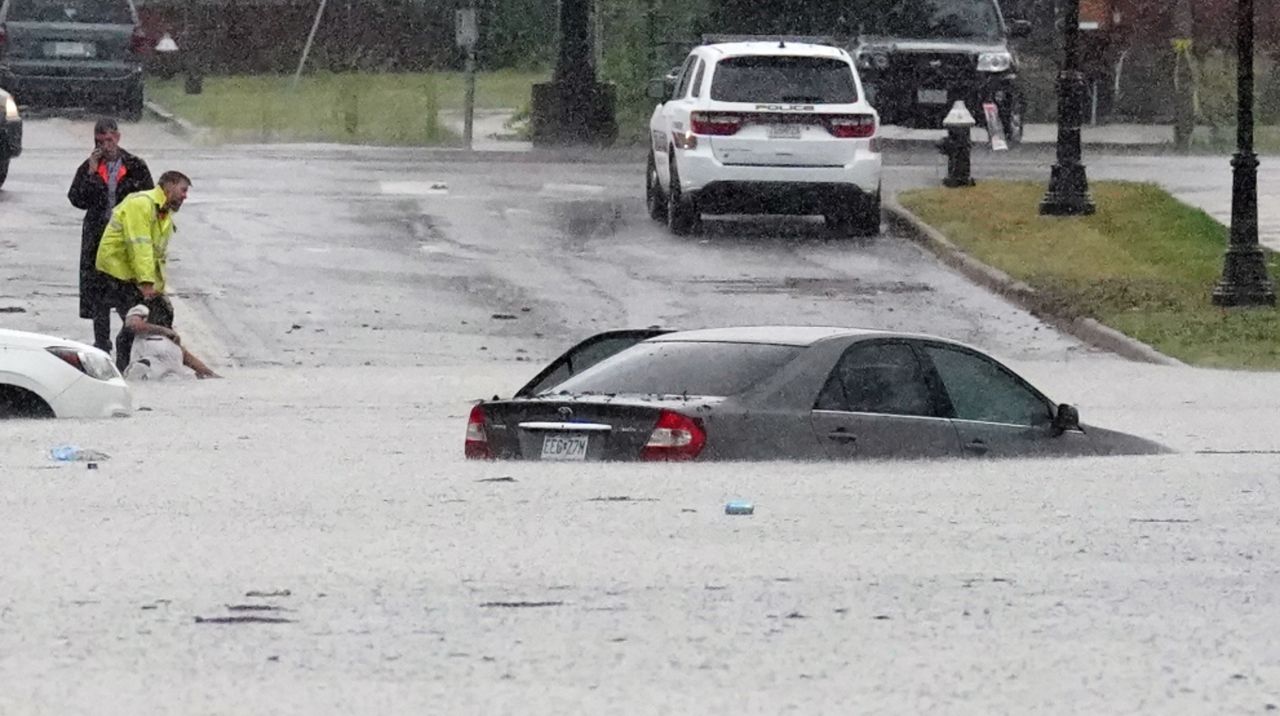 A passerby drags a victim from a flooded vehicle following historic rains causing flooding on streets and houses in St. Louis on Tuesday, July 26, 2022.  Some areas in the St. Louis area received over 11 inches of water from heavy rains late Monday night and Tuesday morning. Photo by Bill Greenblatt/UPI