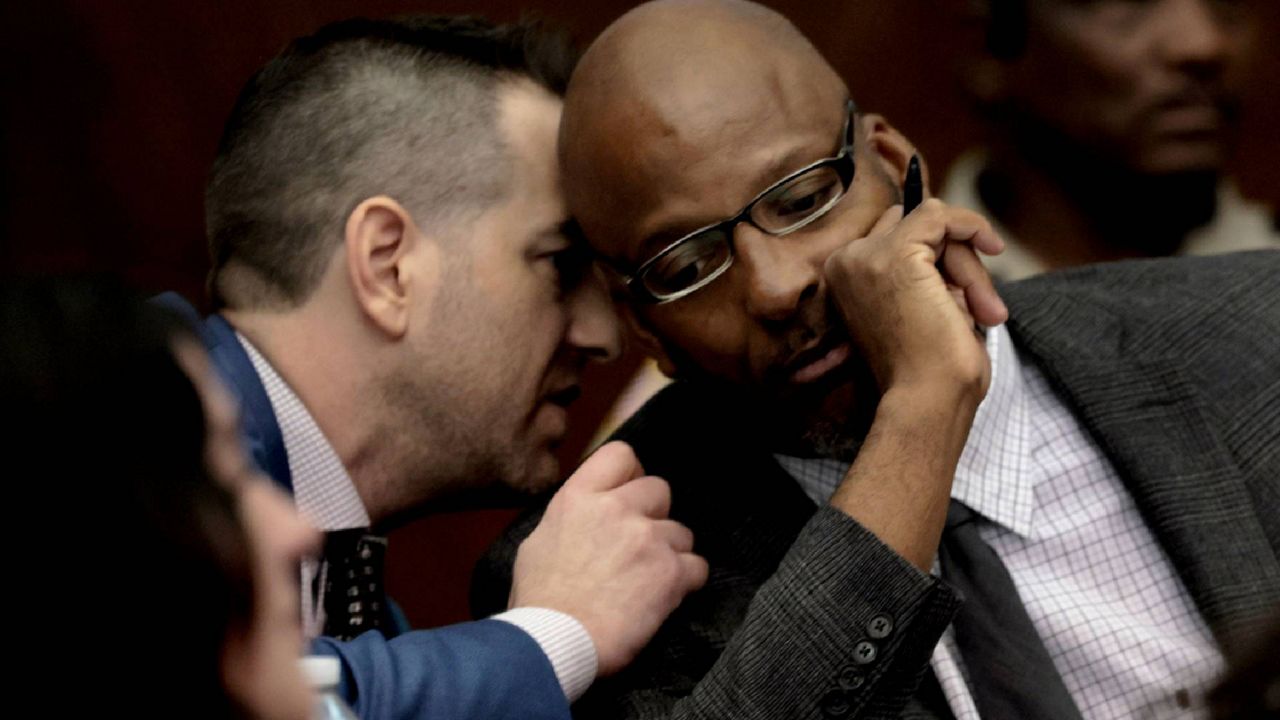 Christopher Dunn, right, listens to his attorney Justin Bonus from New York City during the first day of his hearing to decide whether to vacate his murder conviction, Tuesday, May 21, 2024.  (Laurie Skrivan/St. Louis Post-Dispatch via AP, Pool, File)