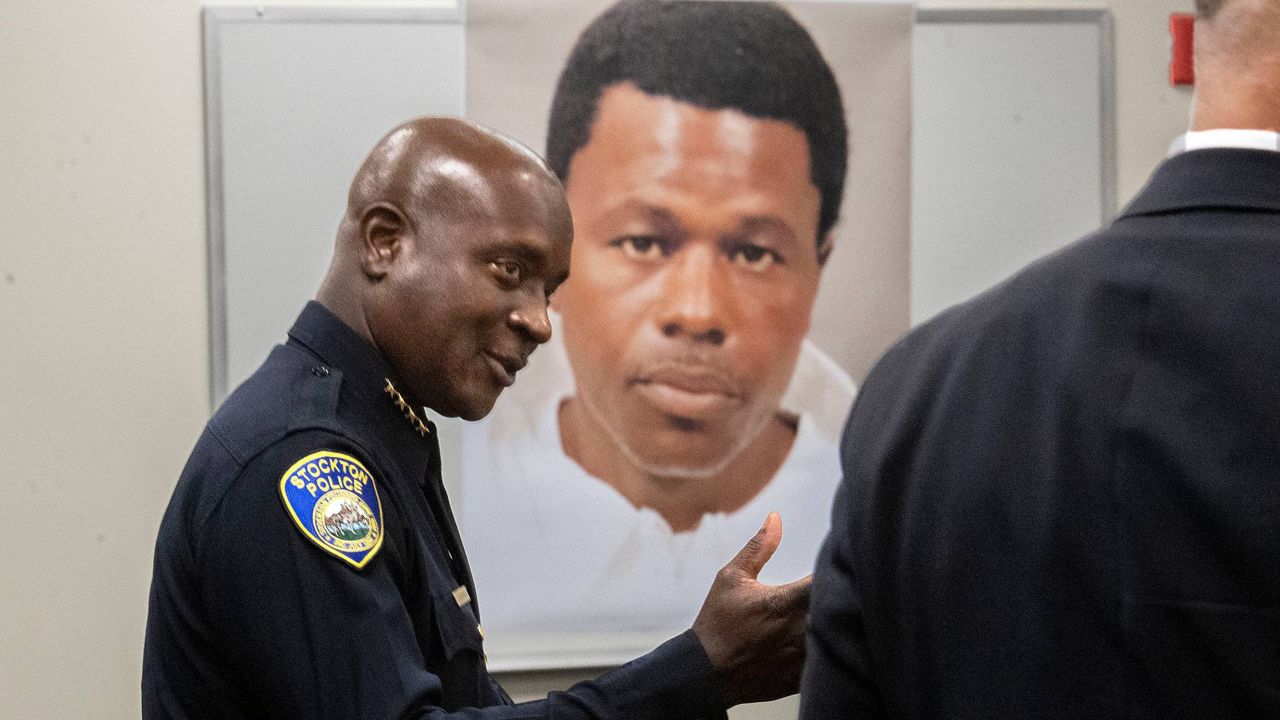 Stockton Police Chief Stanley McFadden speaks during a press conference at the Stockton Police Department headquarters in Stockton, Calif., on the arrest of suspect Wesley Brownlee in the Stockton serial killings on Saturday. Behind McFadden is a booking photo of Brownlee. (Clifford Oto/The Record via AP)