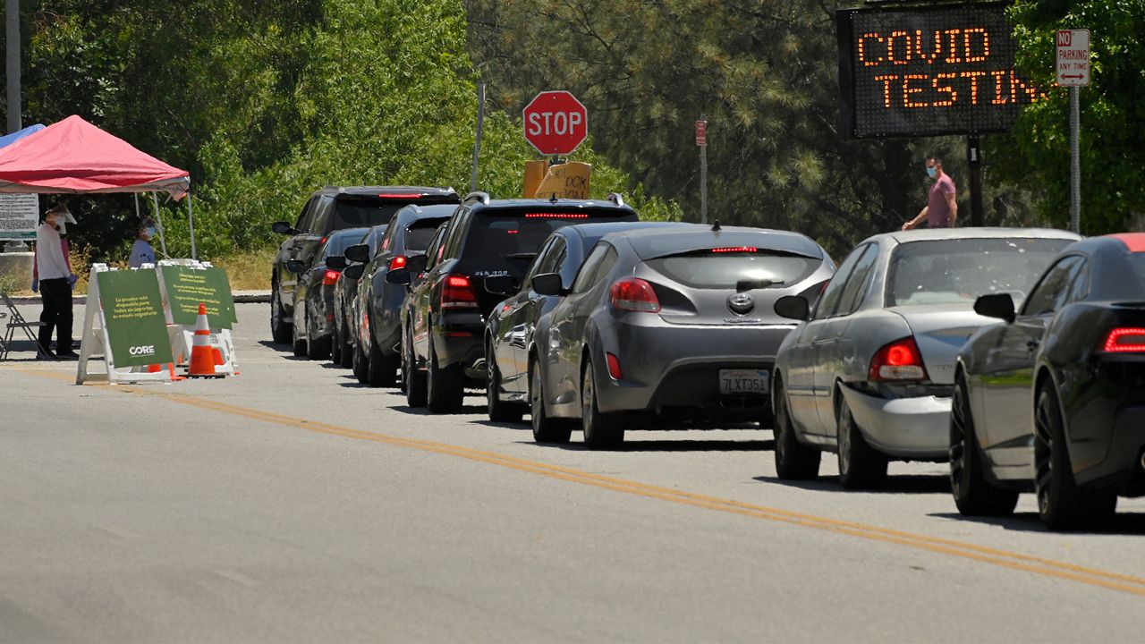 Cars line up for coronavirus testing at Hansen Dam Recreation Center, Tuesday, July 7, 2020, in Los Angeles. Less than two months ago, Los Angeles had so many tests available for coronavirus that tens of thousands were going unused. Today, it's impossible to book an appointment. The current resurgence of the virus has spiked demand in LA and across the state for tests, leading to long lines and a fear that supplies will run low and create a bottleneck in a system that has taken months to expand. (AP Photo/Mark J. Terrill,File)