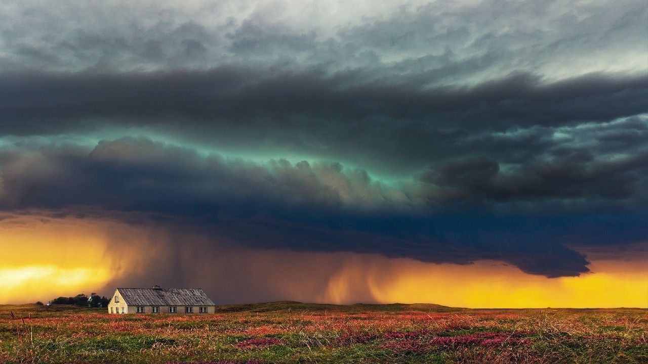 Thunderstorm over farmland photo.