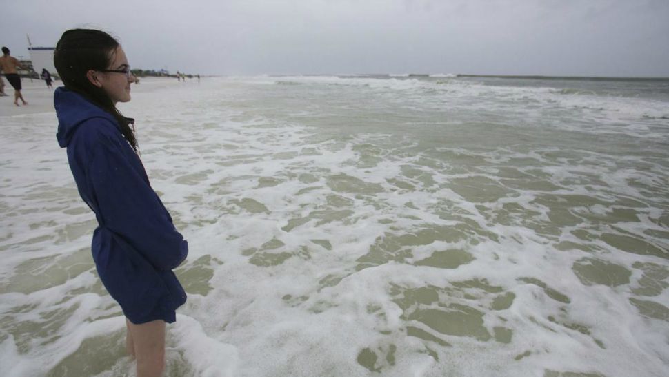 Abigail Odom, 15, watches the waves crash as a subtropical storm makes landfall on Monday, May 28, 2018 in Okaloosa Island, Fla. (AP Photo/Dan Anderson)