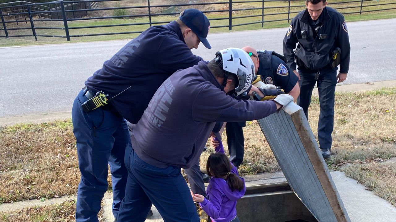 A 12-year-old Texas girl named Tori is rescued from a sewage drain by members of the Southlake Department of Public Safety in this image from January 2022. (Southlake DPS)