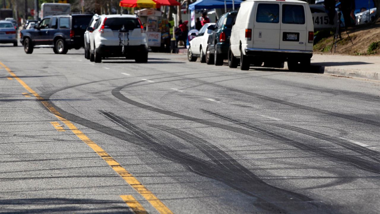Car skid marks are visible along a street in the Chatsworth section of Los Angeles, Thursday, Feb. 26, 2015. (AP Photo/Nick Ut)