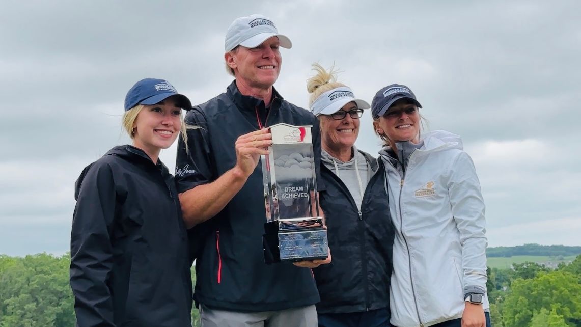 Steve Stricker stands with his family and trophy