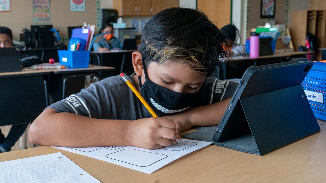 Student wearing mask at school. (AP Images)