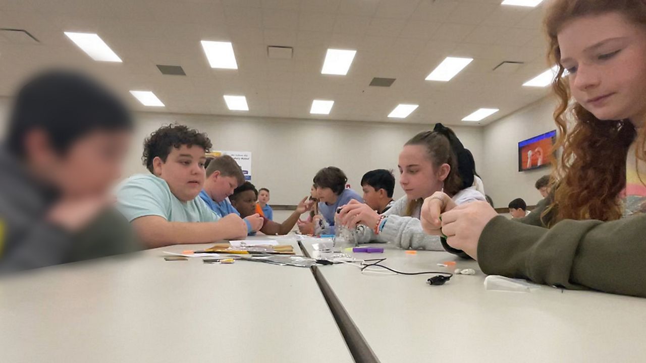 A classroom of students collab on making a "Safe Stopping Robot" for the Boeing Future U Design Challenge. (Spectrum News/Greg Pallone)