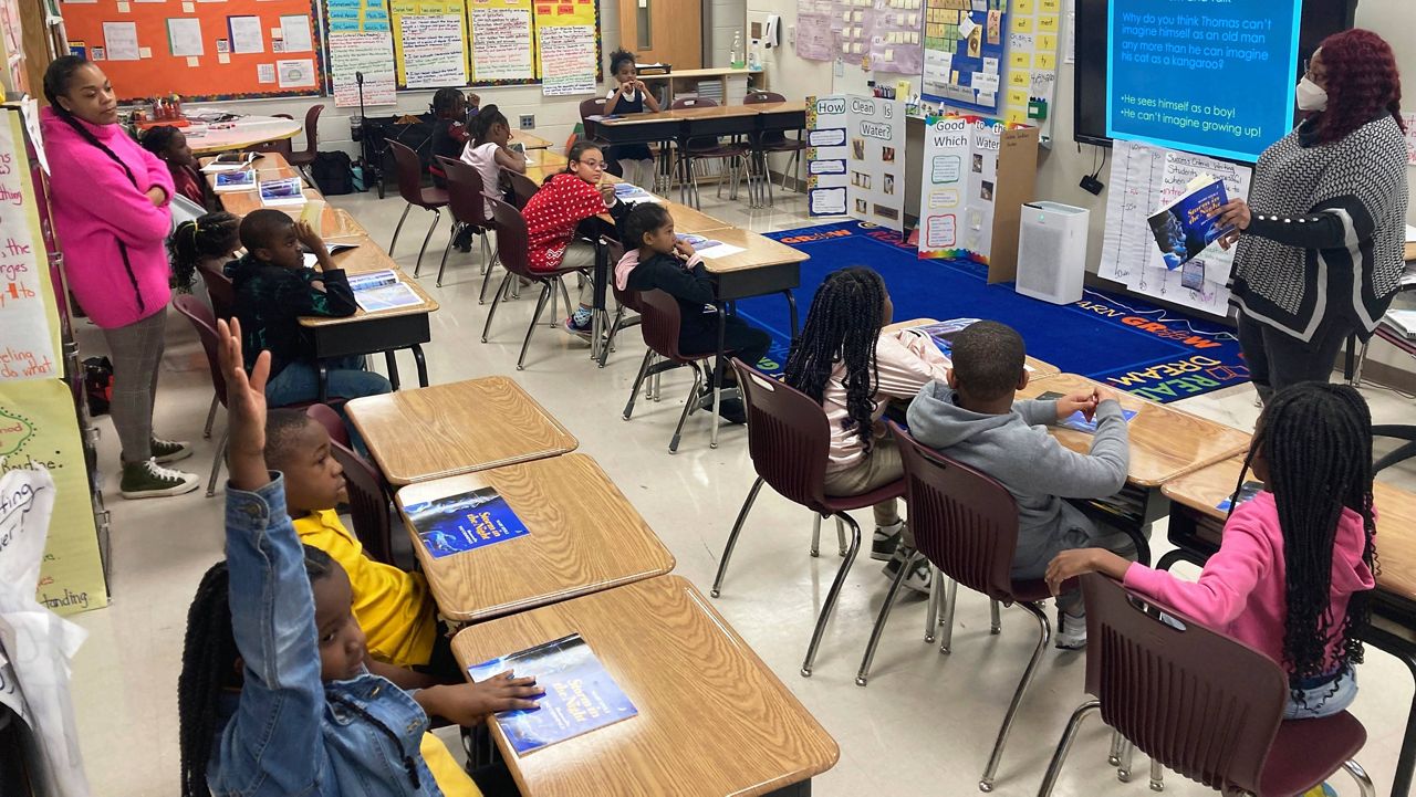 Students answer questions as they read a book with third-grade teacher La'Neeka Gilbert-Jackson, right, at Boyd Elementary School in Atlanta, on Dec. 15, 2022. (AP Photo/Sharon Johnson, File)