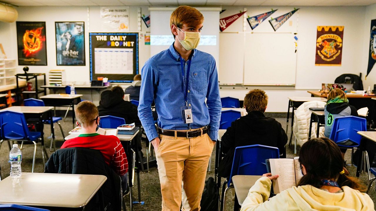 In this Dec. 10, 2020, file photo, Cooper Hanson, a substitute teacher at the Greenfield Intermediate School in Greenfield, Ind., is photographed in a classroom. (AP Photo/Michael Conroy File)