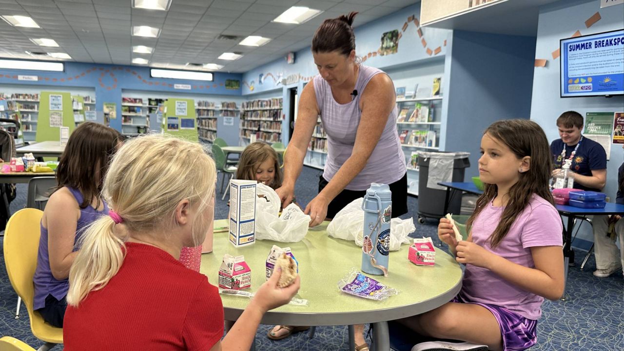 Volusia County parent Carmen Crenshaw and her kids have been going to the Daytona Beach Regional Library for years. The library participates in the Summer BreakSpot program. (Spectrum News/Reagan Ryan)