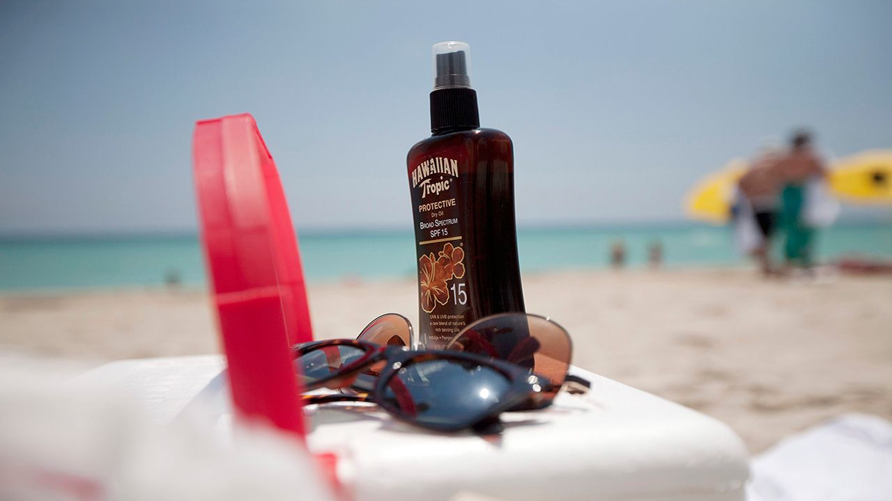 This Wednesday, May 9, 2012 file photo shows a bottle of sun tan lotion and sunglasses on top of a cooler.