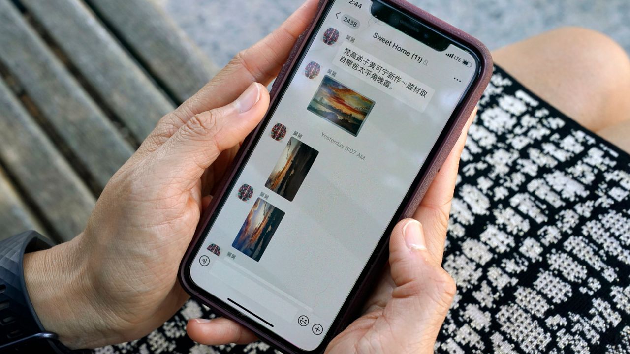 Sha Zhu, of Washington, shows the app WeChat on her phone, which she uses to keep in touch with family and friends in the U.S. and China, Tuesday Aug. 18, 2020, in Washington. For months, the Elon Musk has expressed interest in creating his own version of China’s WeChat — a “super app” that does video chats, messaging, streaming and payments — for the rest of the world.. At least, that is, once he's done buying Twitter after months of legal infighting over the $44 billion purchase agreement he signed in April 2022.