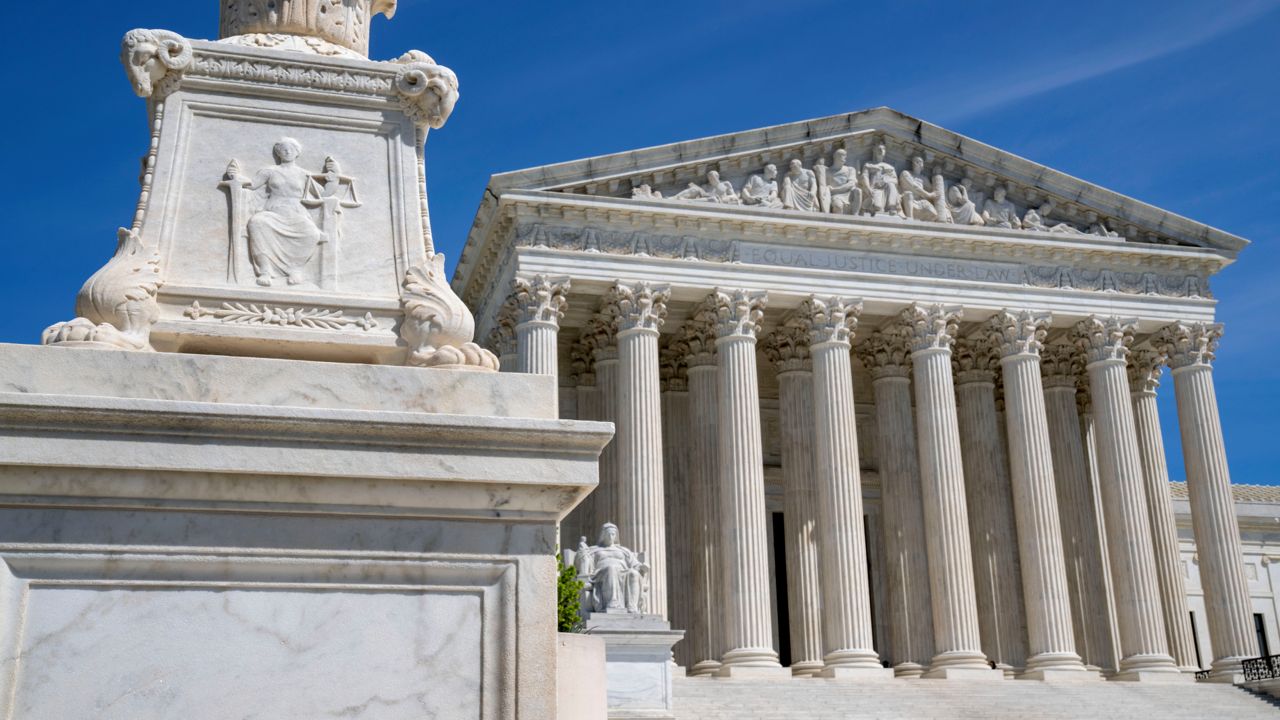 The U.S. Supreme Court is seen, with a carving of Justice in the foreground, April 19, 2023, in Washington.