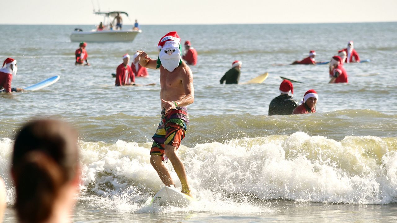 Surfing Santas taking over Cocoa Beach on Christmas Eve