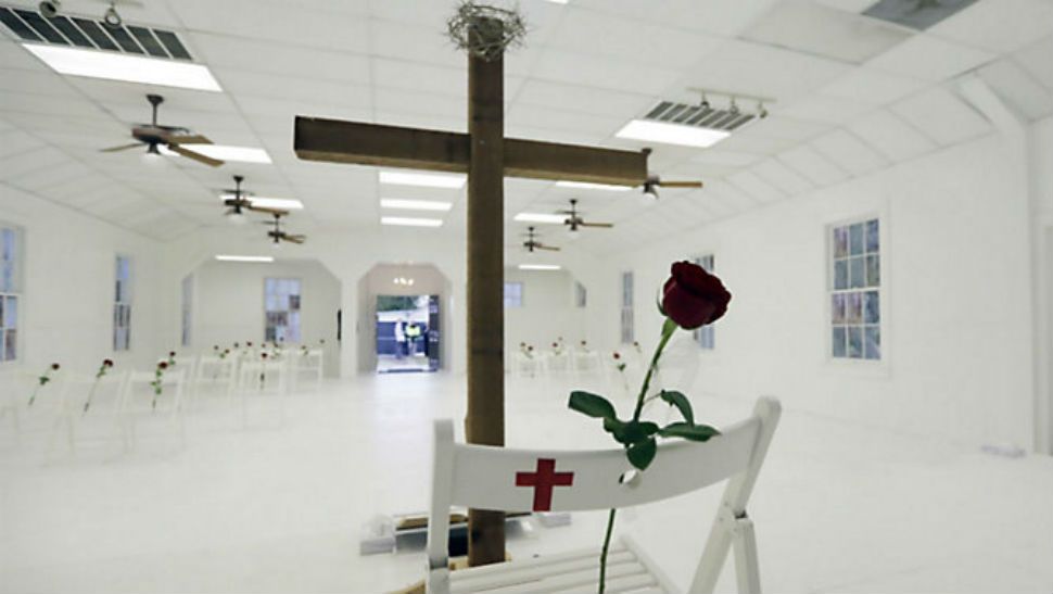 A memorial for the victims of the shooting at Sutherland Springs Baptist Church includes 26 white chairs, each painted with a cross and and rose, placed in the sanctuary, Sunday, Nov. 12, 2017, in Sutherland Springs, Texas. A man opened fire inside the church in the small South Texas community last week, killing more than two dozen. (AP Photo/Eric Gay)