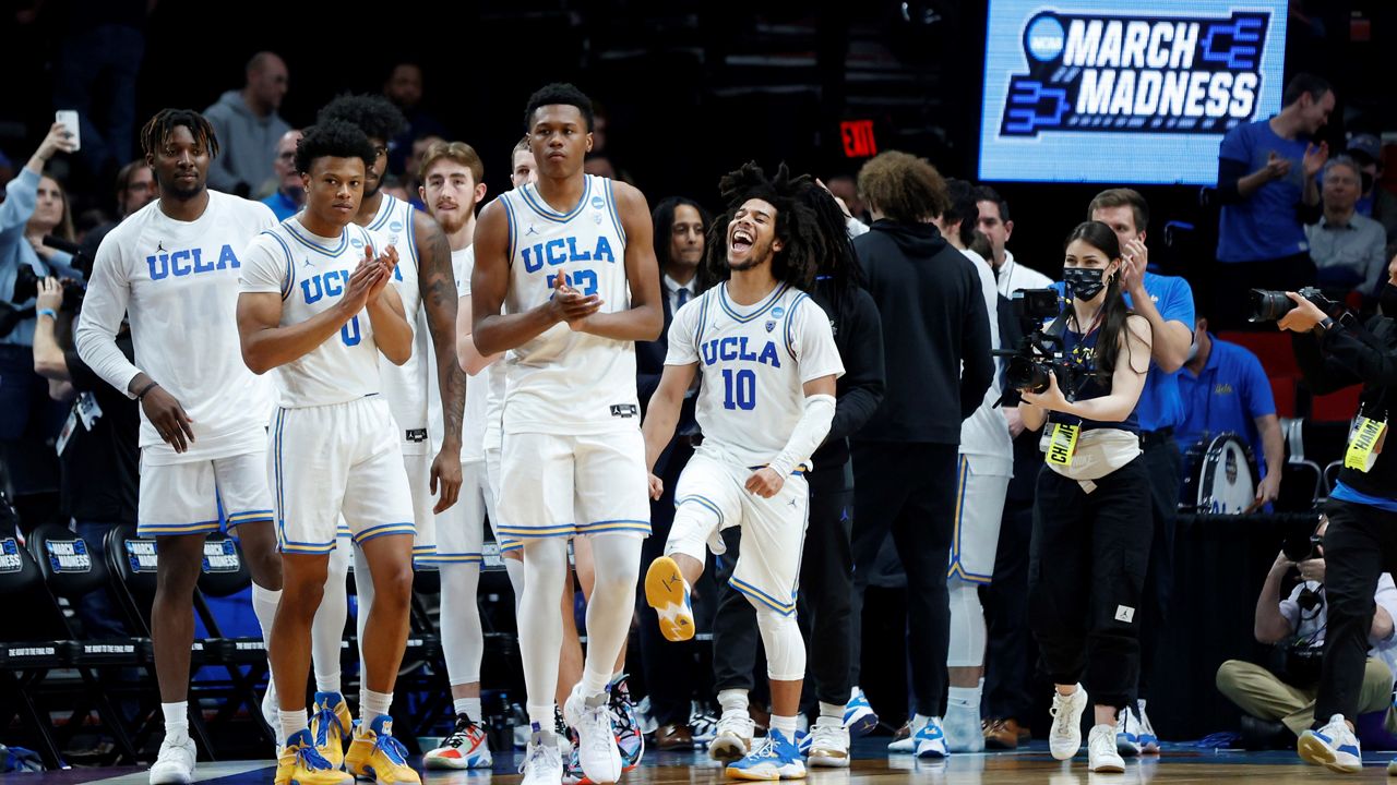 UCLA guard Tyger Campbell (10) celebrates with teammates at the end of a second-round NCAA college basketball tournament game against St. Mary's, Saturday, March 19, 2022, in Portland, Ore. UCLA won 72-56. (AP Photo/Craig Mitchelldyer)