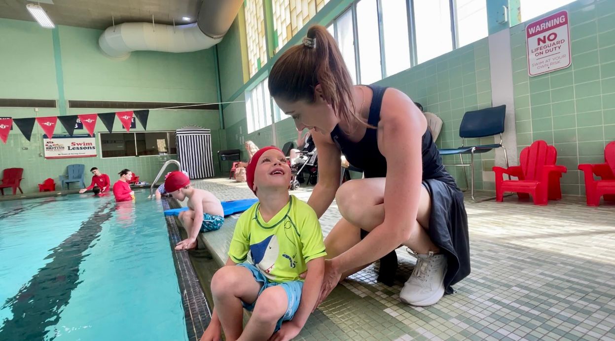 Theodore telling his mom, Catie, about his swim lesson.