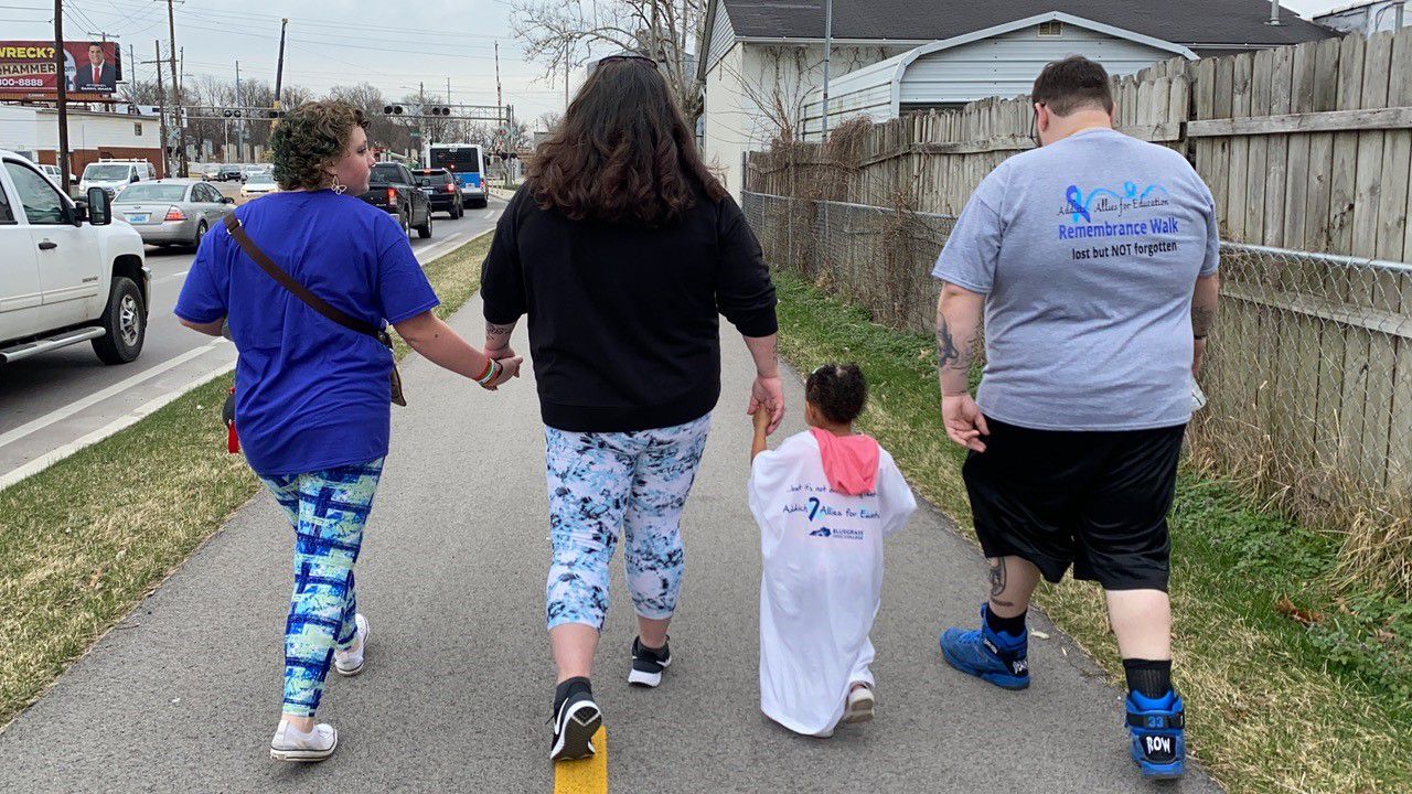 Sylvia Kidwell walks with her two daughters, her husband during an Addicts & Allies for Education walk of remembrance. (Spectrum News 1/Diamond Palmer)