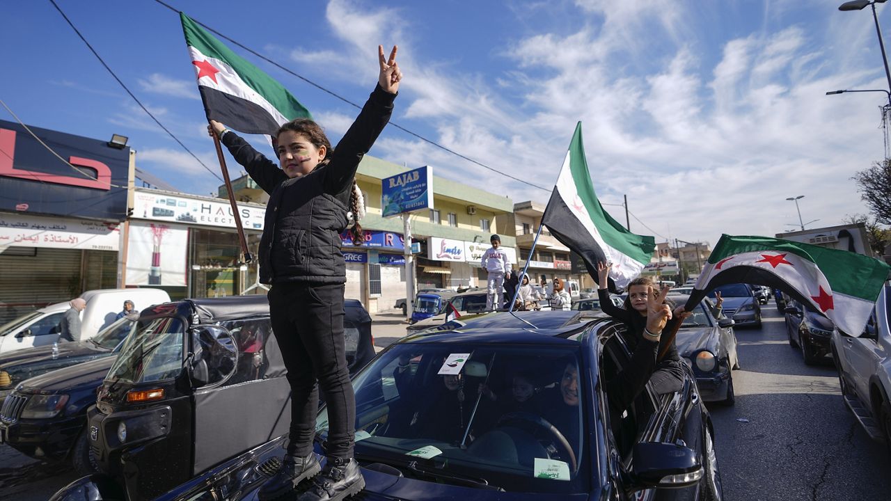 Syrians celebrate the arrival of opposition fighters in Damascus, Syria, Sunday, Dec. 8, 2024. (AP Photo/Omar Sanadiki)