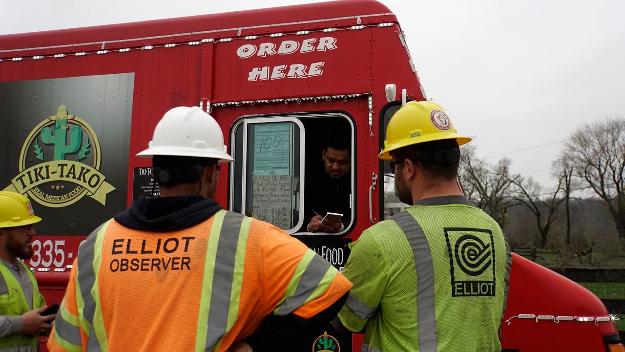 taco_truck_milton_tornado_KY_0315 Edgar Barrera serves food for free to a group of linemen working to restore power to Milton, Ky (Spectrum News 1/Mason Brighton)